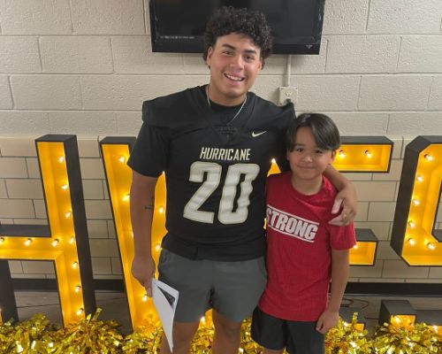  Football poses with HWES student